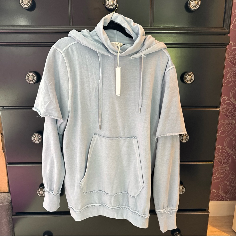 Baby blue hoodie with neck warmer by the laundry room. Sz m